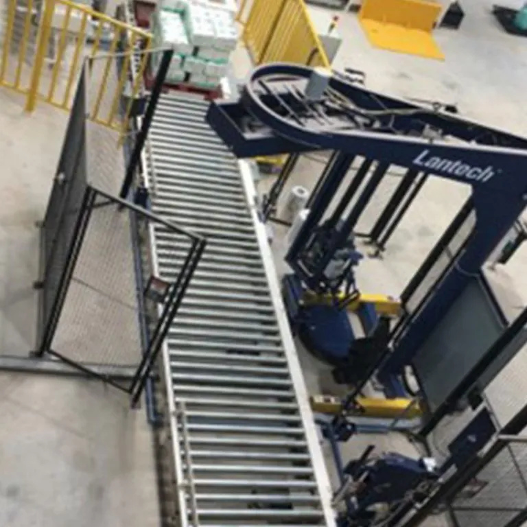 Lantech pallet stretch wrapper fed by a roller conveyor, installed on site
